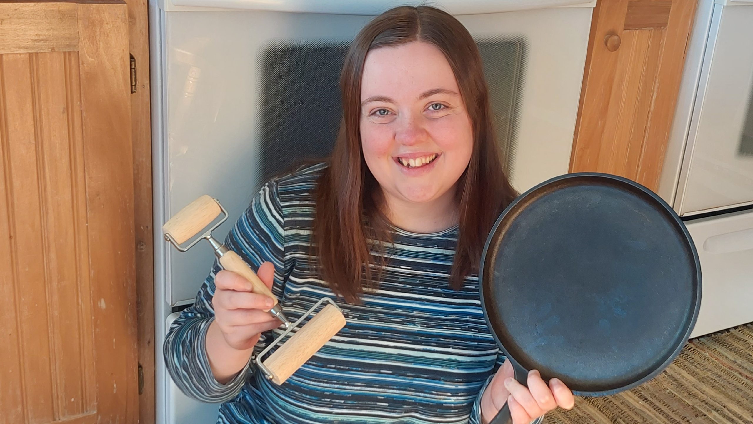 Rachel holding Food Prep Tools in the kitchen.