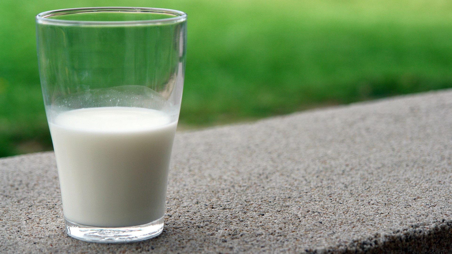 Raw milk in a clear glass.